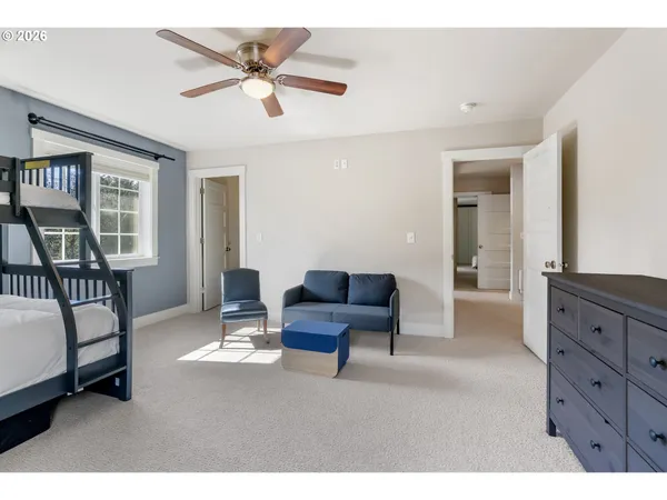 a living room with furniture and two windows
