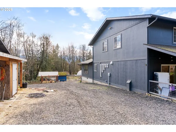 a view of a house with a patio and a yard