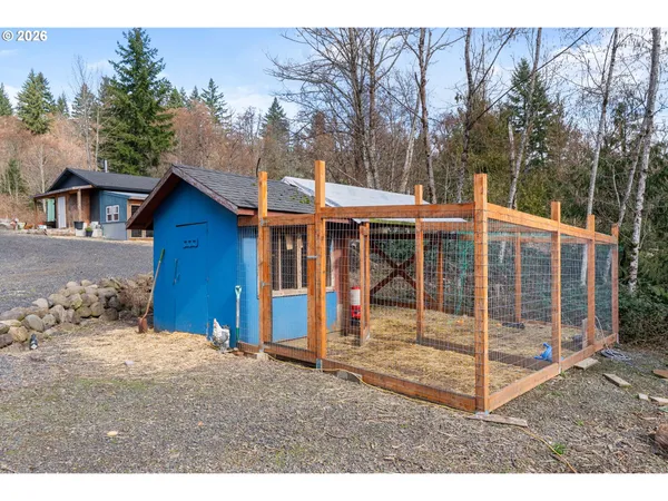a view of a house with a yard and wooden fence