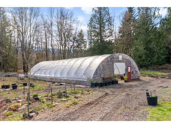 a backyard of a house with barbeque oven and outdoor seating