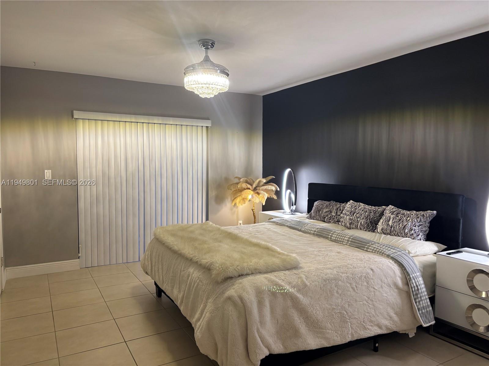 8384 Southwest 154th Avenue, Unit 68 Miami, FL 33193 - Photo 20 of 47 a bedroom with a bed and a chandelier