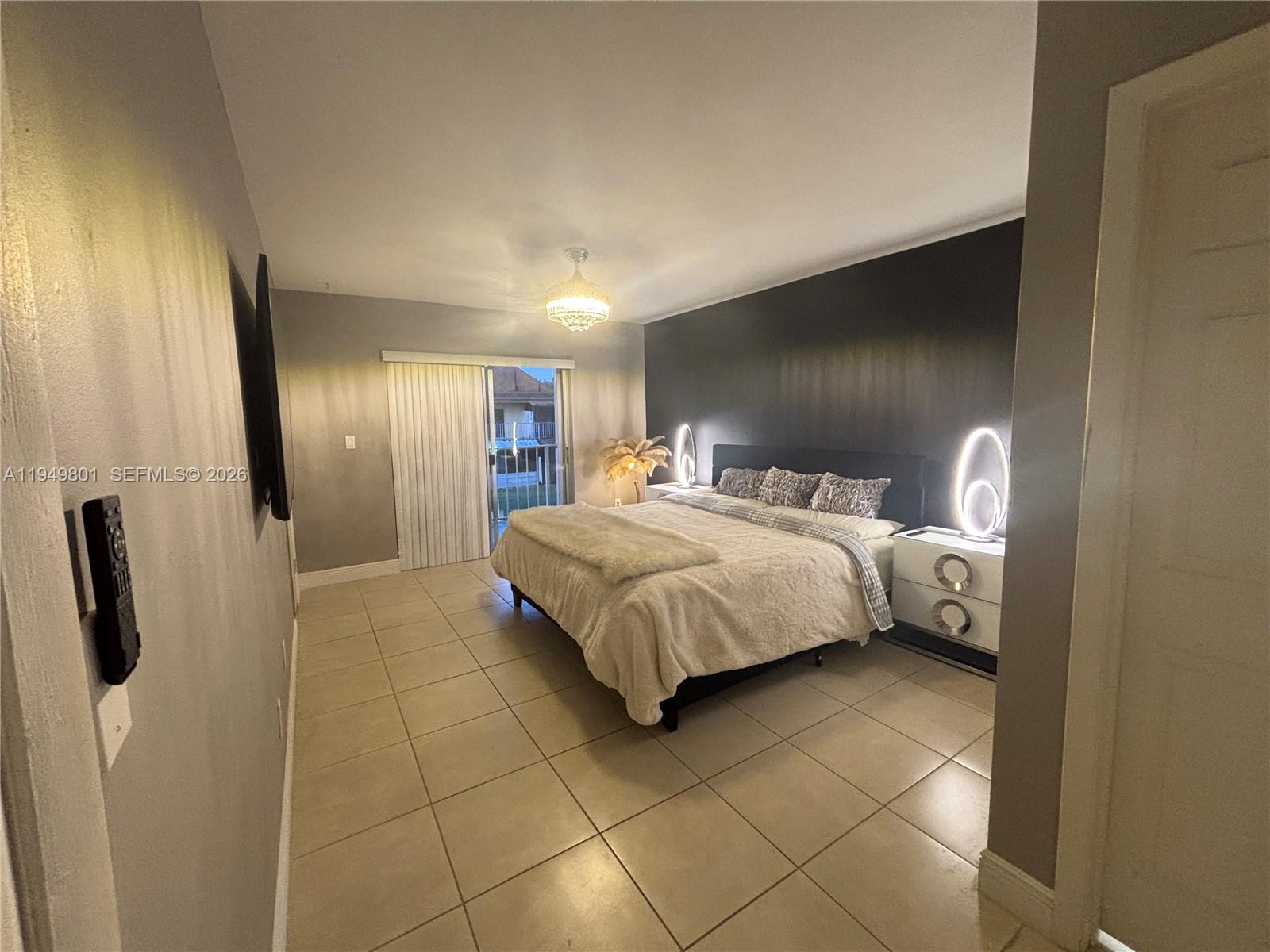 8384 Southwest 154th Avenue, Unit 68 Miami, FL 33193 - Photo 27 of 47 a bedroom with a bed and a refrigerator