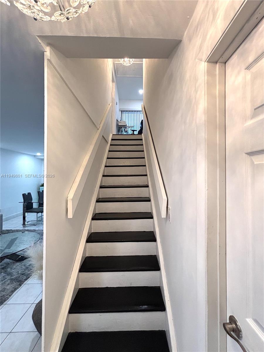 8384 Southwest 154th Avenue, Unit 68 Miami, FL 33193 - Photo 35 of 47 a view of entryway with wooden floor and stairs