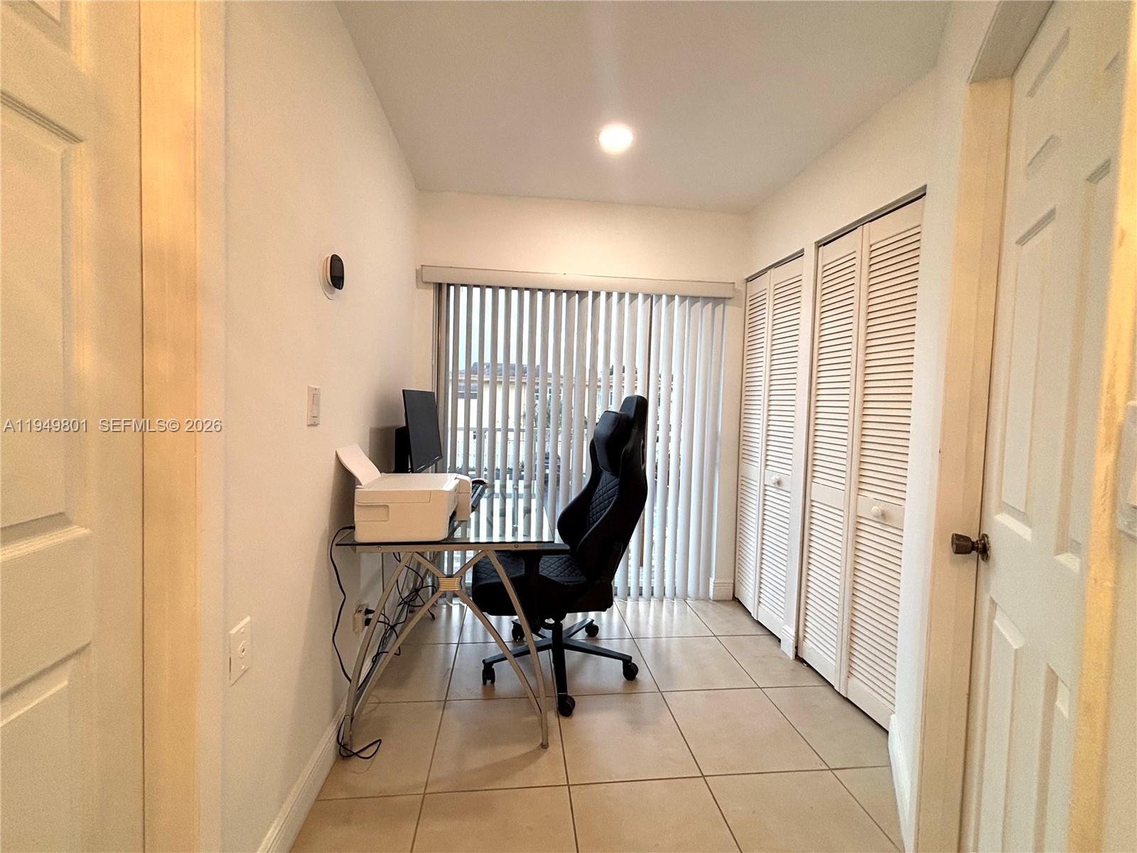 8384 Southwest 154th Avenue, Unit 68 Miami, FL 33193 - Photo 36 of 47 a view of a hallway with chairs and a potted plant