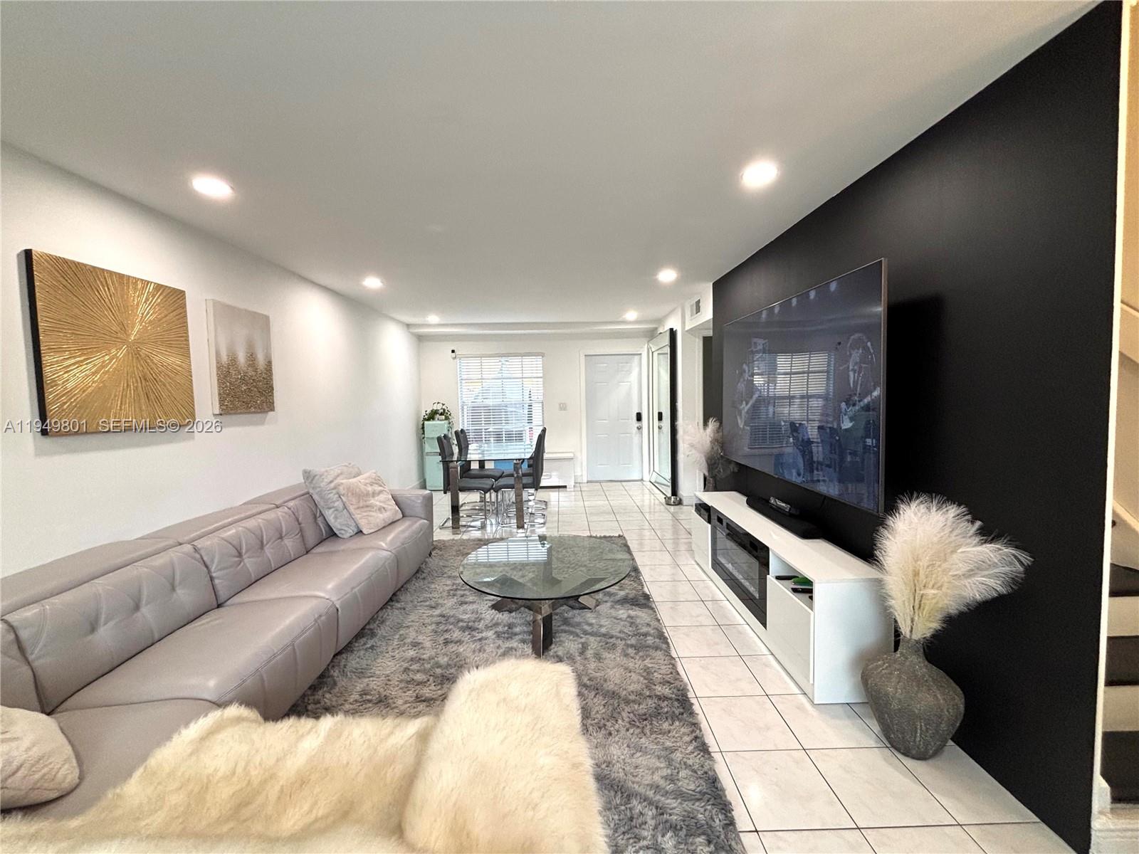 8384 Southwest 154th Avenue, Unit 68 Miami, FL 33193 - Photo 9 of 47 a living room with furniture and a fireplace