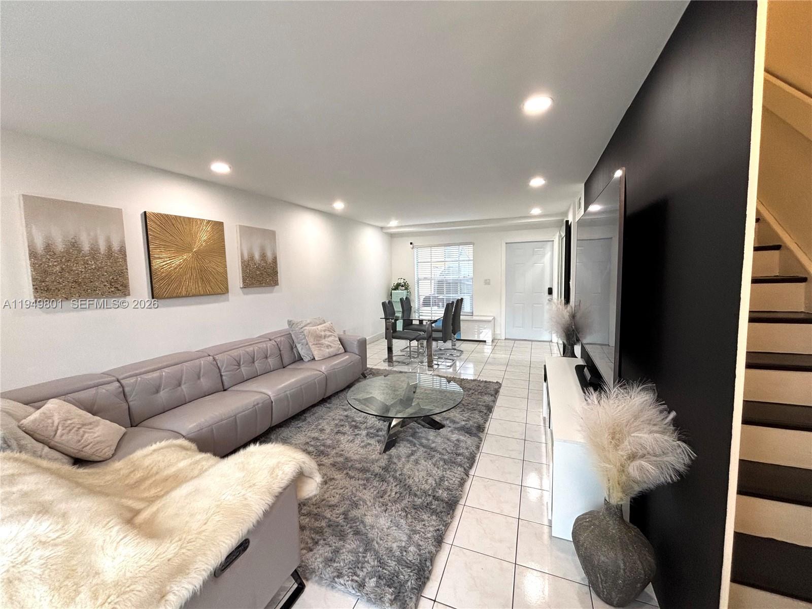 8384 Southwest 154th Avenue, Unit 68 Miami, FL 33193 - Photo 10 of 47 a living room with furniture and a potted plant