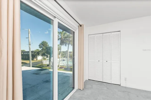 an aerial view of residential houses with outdoor space and ocean view