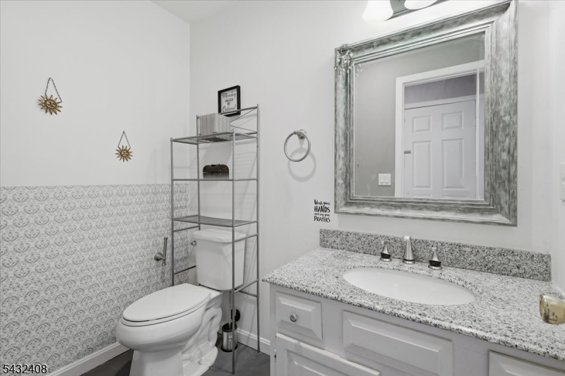 112 Knob Hill Road Hackettstown, NJ 07840 - Photo 19 of 32 a bathroom with a granite countertop toilet a sink and mirror