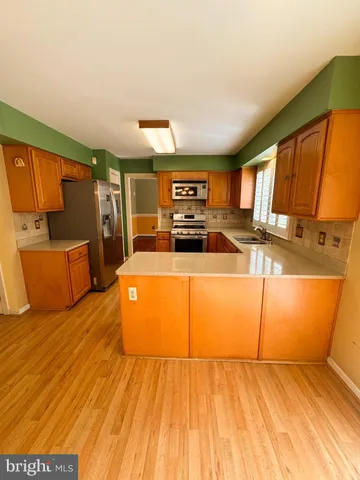 a kitchen with stainless steel appliances granite countertop a sink and cabinets