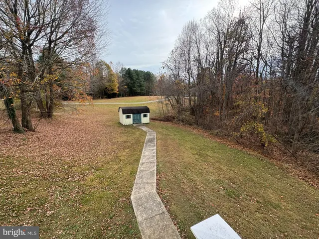 a view of a backyard with wooden fence