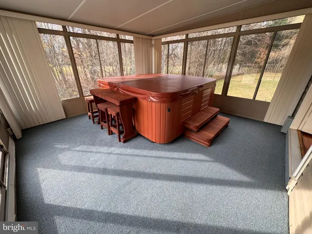 a room with a bed and a table chair