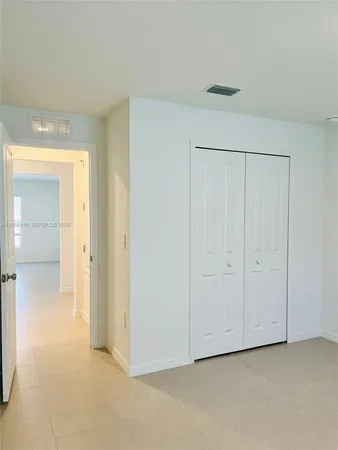 a view of an empty room and closet area