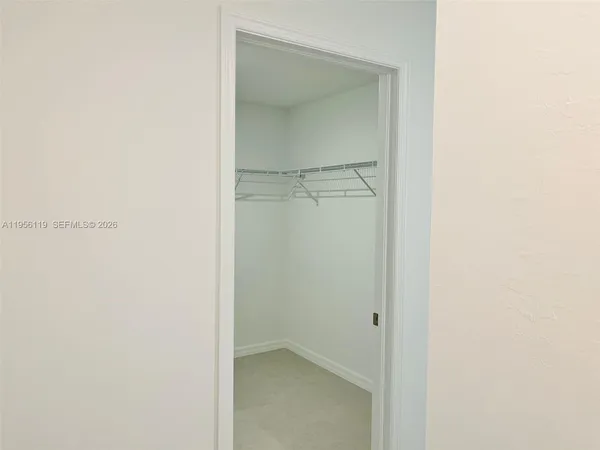a bathroom with a granite countertop sink a window and a shower