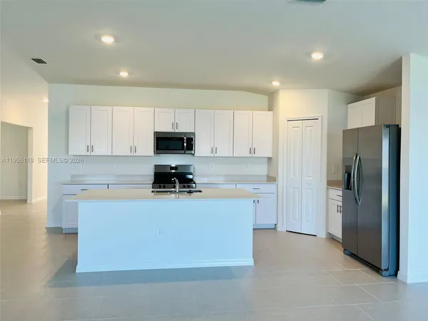 a kitchen with cabinets and stainless steel appliances