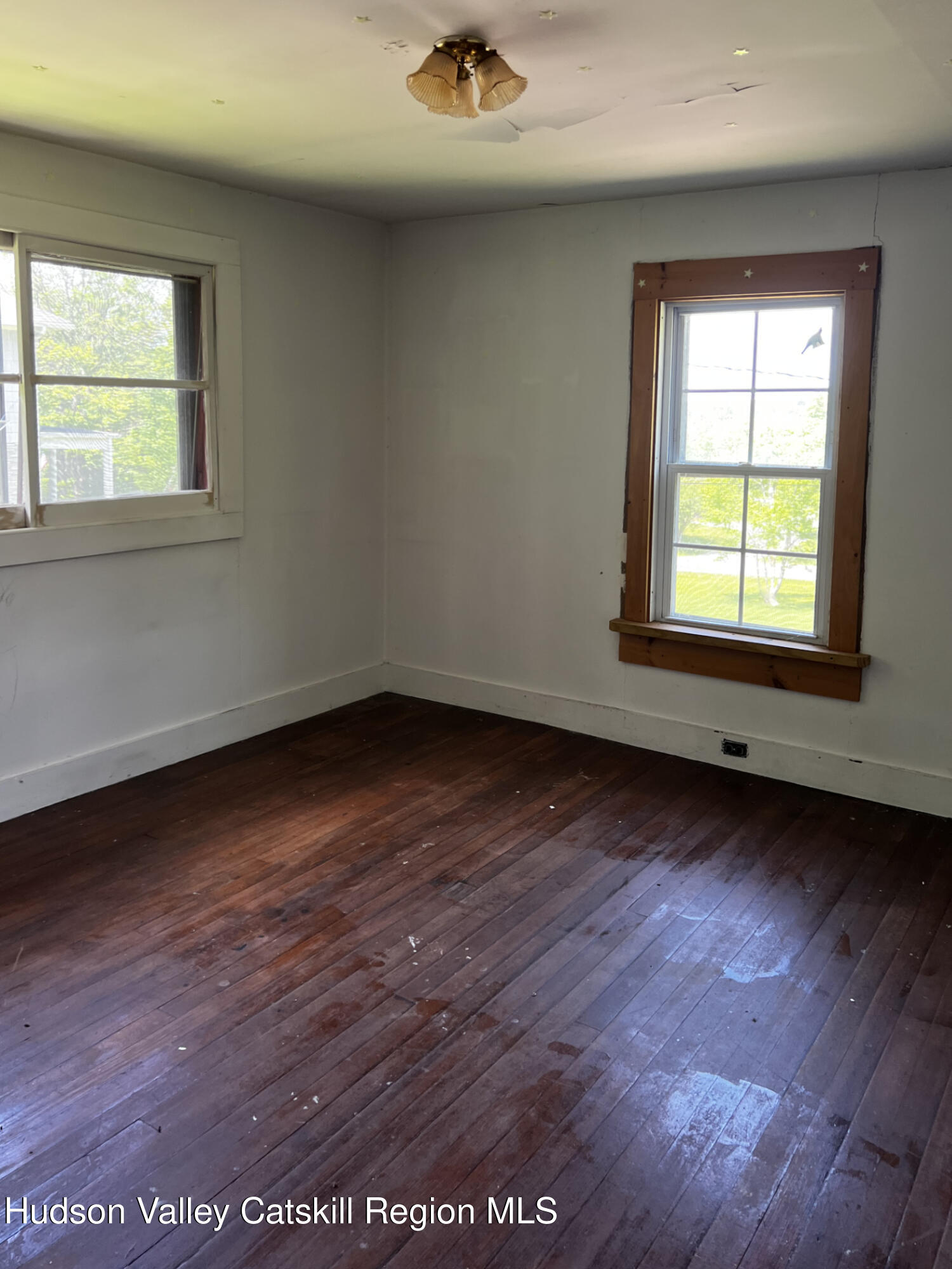 217 Platte Clove Road Elka Park, NY 12427 - Photo 11 of 18 an empty room with wooden floor and windows