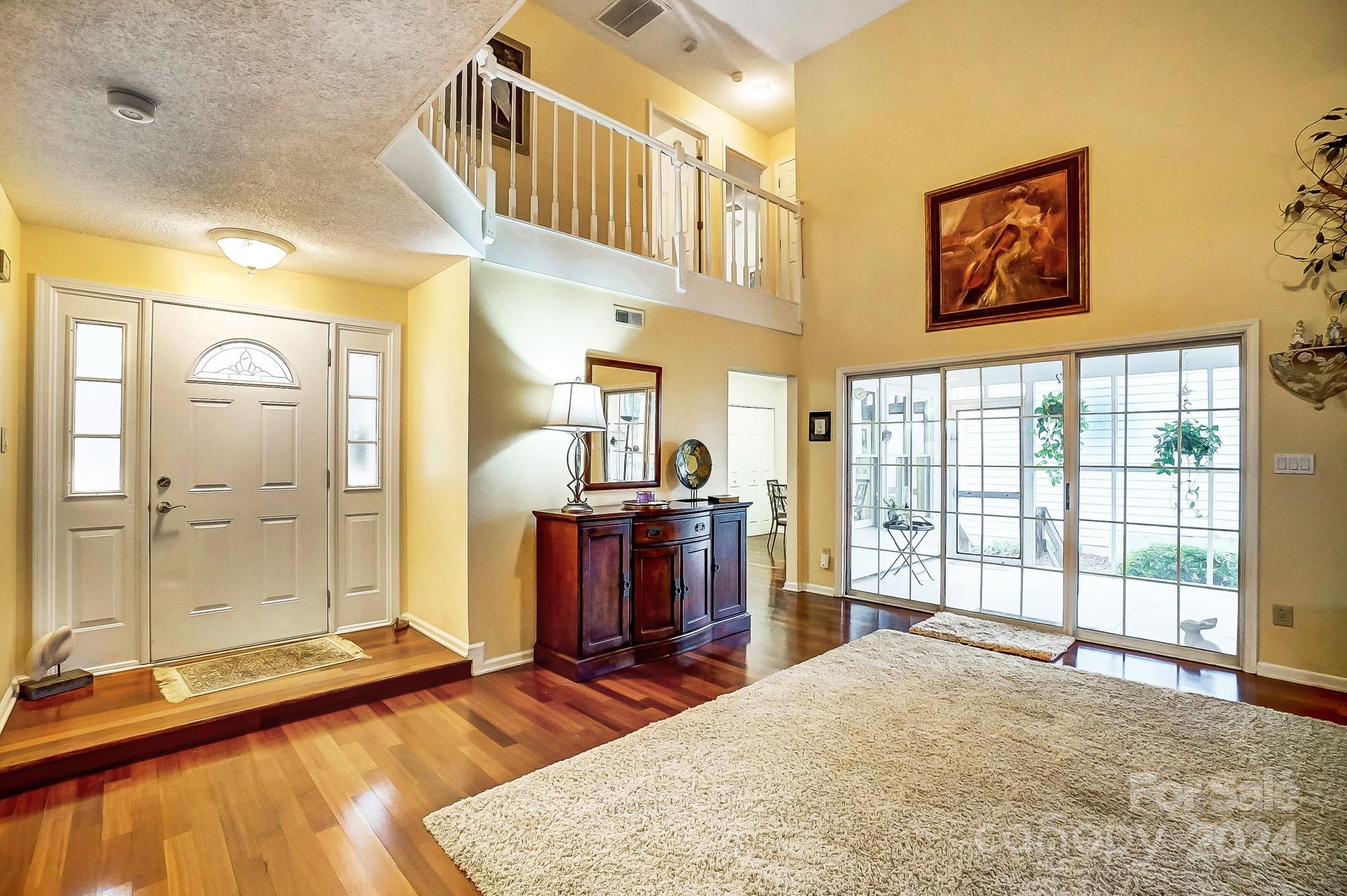 10454 Fairway Ridge Road Charlotte, NC 28277 - Photo 5 of 41 a bedroom with a bed and a large window with wooden floor