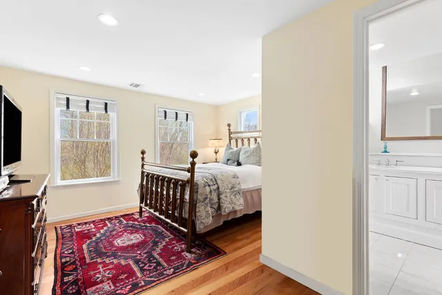 a bedroom with a bed and wooden floor