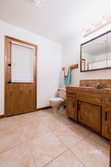 305 South Locust Street Ridgecrest, CA 93555 - Photo 27 of 36 a kitchen with a sink and a stove