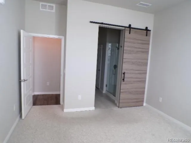an empty room with an entrance to other room