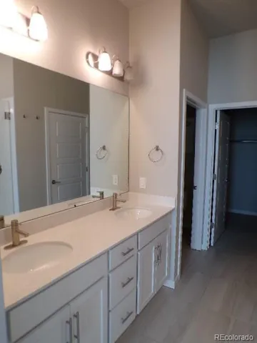 a spacious bathroom with a double vanity sink and a mirror
