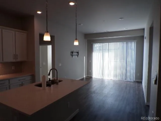 a view of a kitchen with a sink cabinets and wooden floor