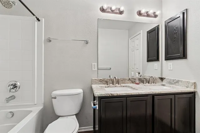 a bathroom with a toilet sink and mirror a bathtub
