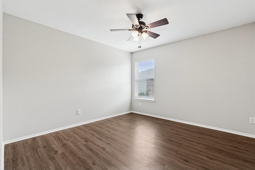 3005 Groveland Terrace Denton, TX 76210 - Photo 19 of 26 a view of a room with wooden floor and a ceiling fan