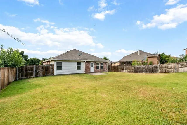 a large house with a big yard and large trees