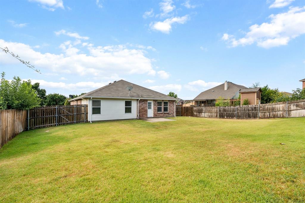 3005 Groveland Terrace Denton, TX 76210 - Photo 24 of 26 a large house with a big yard and large trees
