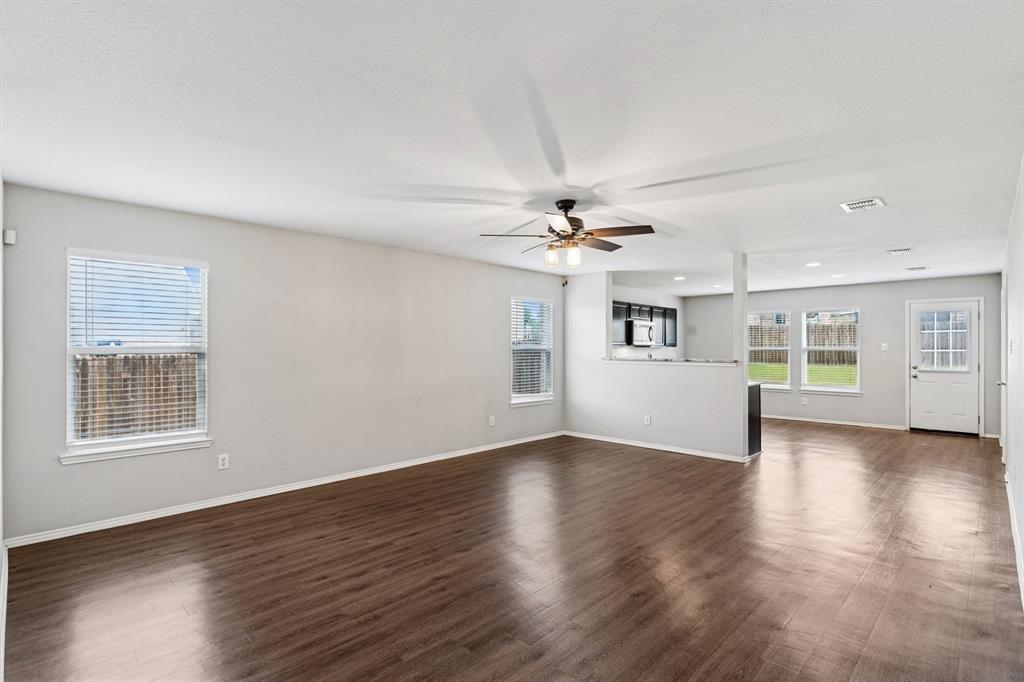 3005 Groveland Terrace Denton, TX 76210 - Photo 4 of 26 a view of an empty room with a window and wooden floor