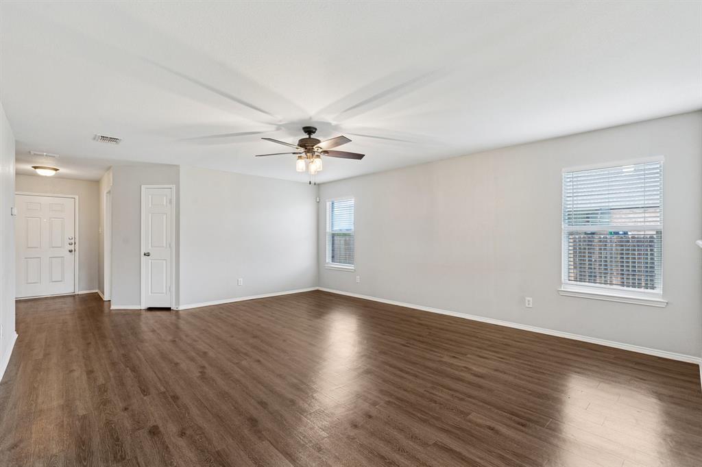 3005 Groveland Terrace Denton, TX 76210 - Photo 7 of 26 a view of an empty room with wooden floor and a window