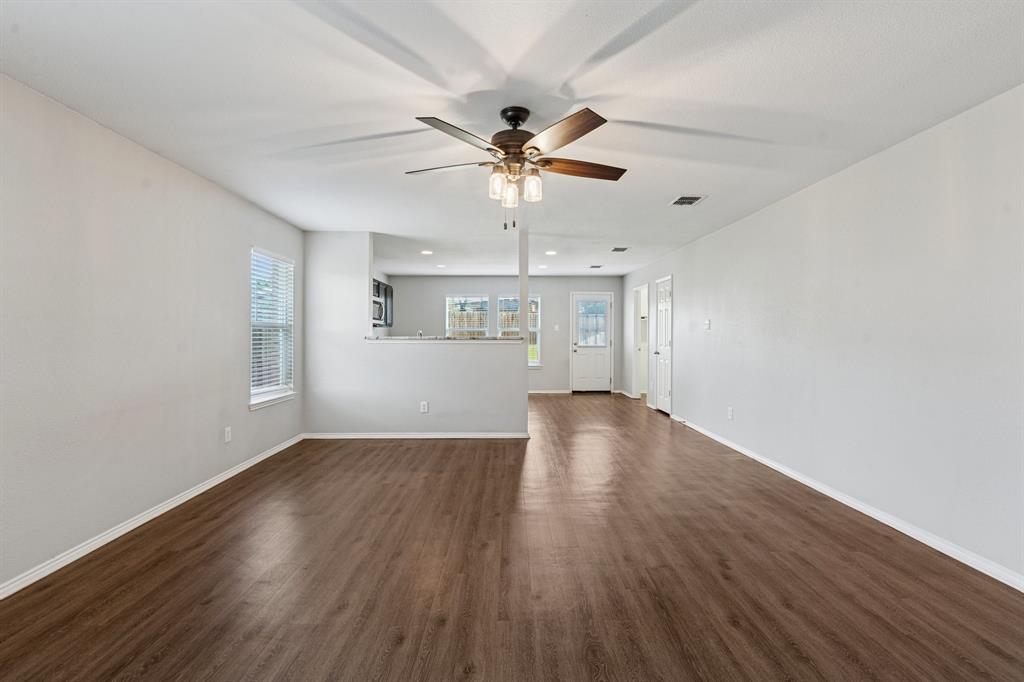 3005 Groveland Terrace Denton, TX 76210 - Photo 8 of 26 wooden floor in an empty room with a window