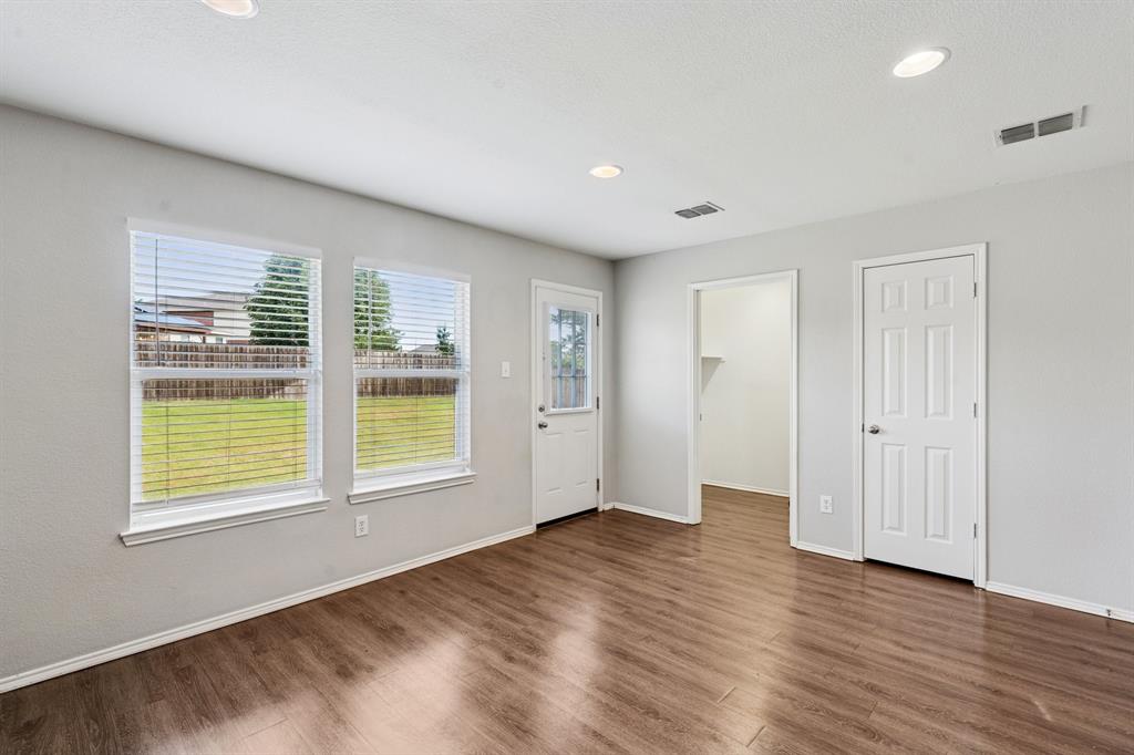 3005 Groveland Terrace Denton, TX 76210 - Photo 10 of 26 a view of an empty room with wooden floor and a window