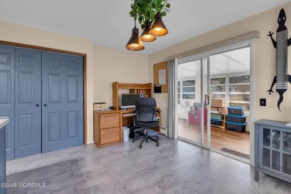 a view of a workspace with furniture and a window