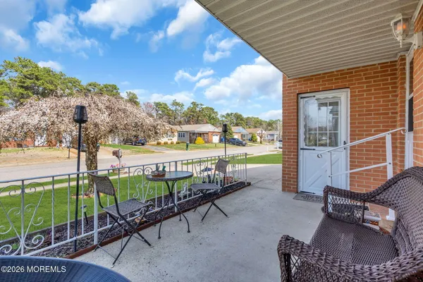 a view of a porch with furniture and a yard