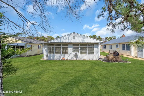 a view of a house with a backyard