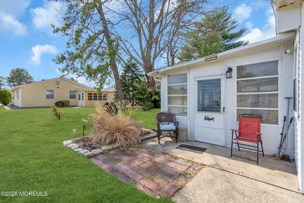 a view of backyard of house with outdoor seating and green space