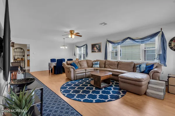 a living room with furniture a rug and a large window
