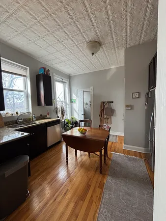 a view of a dining room with furniture and window