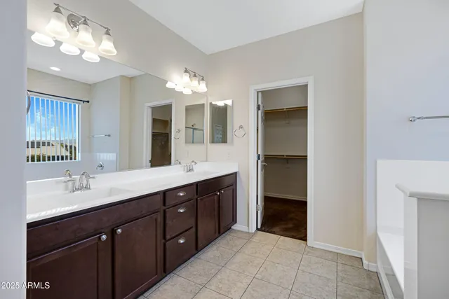 a spacious bathroom with a double vanity sink and a mirror