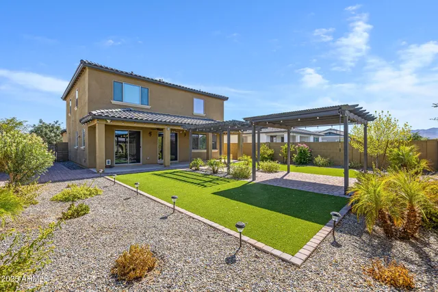 a view of an house with backyard porch and sitting area