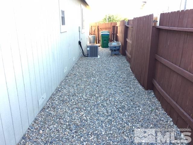 7687 Corso Street Reno, NV 89506 - Photo 5 of 24 a view of a pathway with a wooden fence