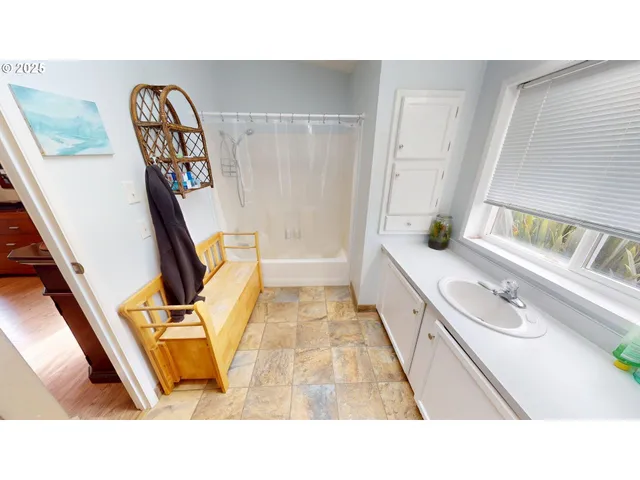 a bathroom with a tub sink and mirror