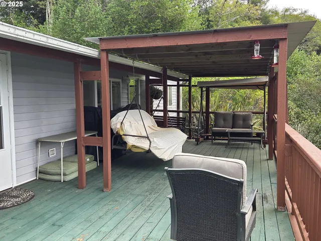 a view of a patio with couches chairs and a wooden floor