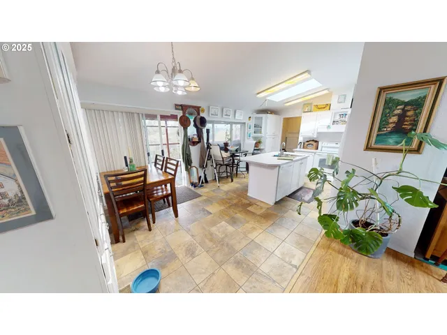 a living room with patio furniture and a chandelier