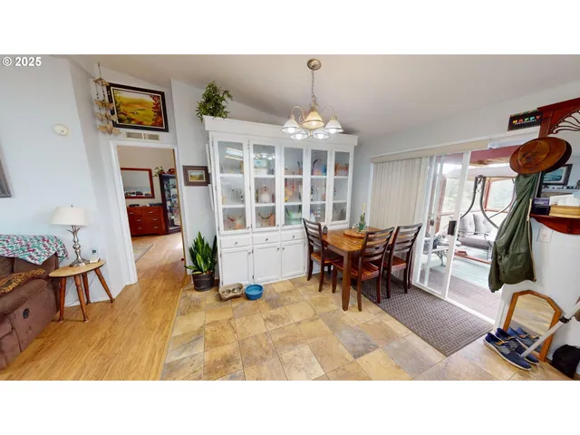 a living room with furniture and a dining table