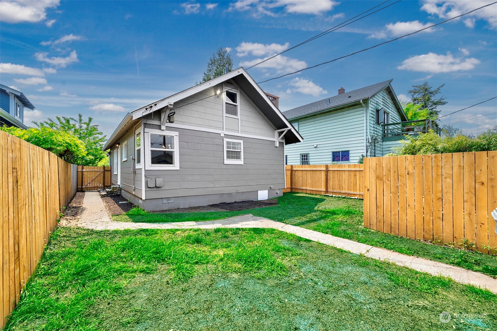 2707 Victor Place Everett, WA 98201 - Photo 18 of 30 a view of a backyard with wooden fence and a small cabin