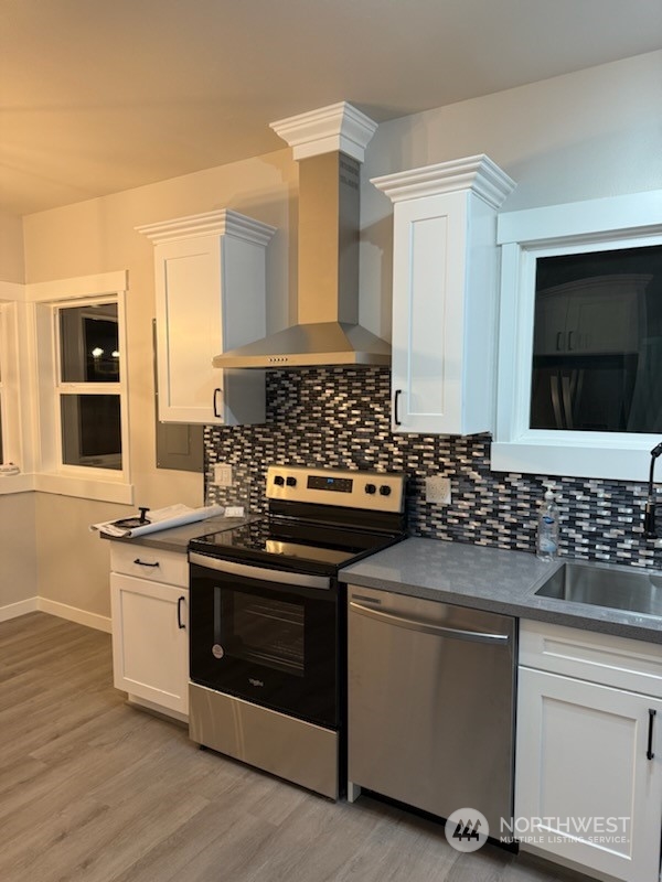 2707 Victor Place Everett, WA 98201 - Photo 8 of 30 a kitchen with stainless steel appliances white cabinets and a stove top oven