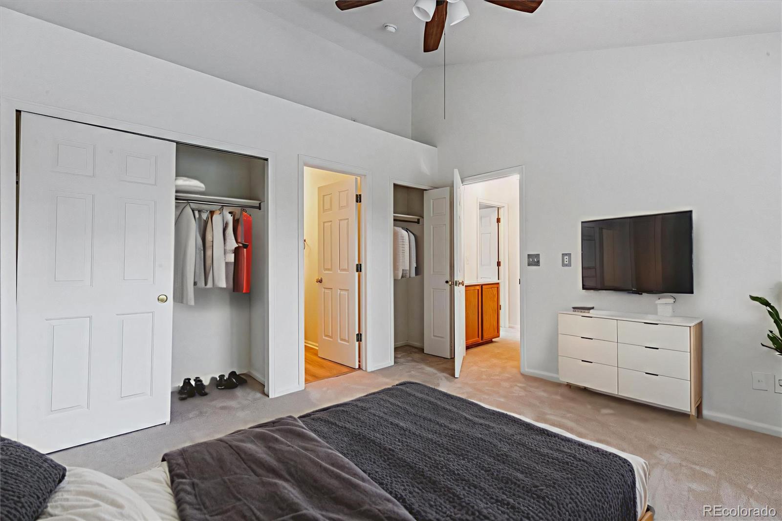 260 West Jamison Circle, Unit 13 Littleton, CO 80120 - Photo 11 of 24 a bedroom with furniture and a flat screen tv