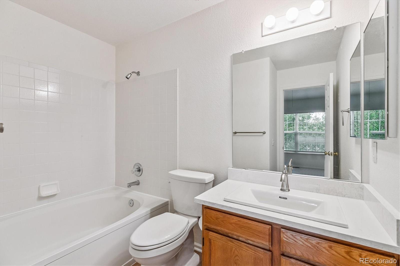 260 West Jamison Circle, Unit 13 Littleton, CO 80120 - Photo 15 of 24 a bathroom with a sink toilet tub vanity and shower